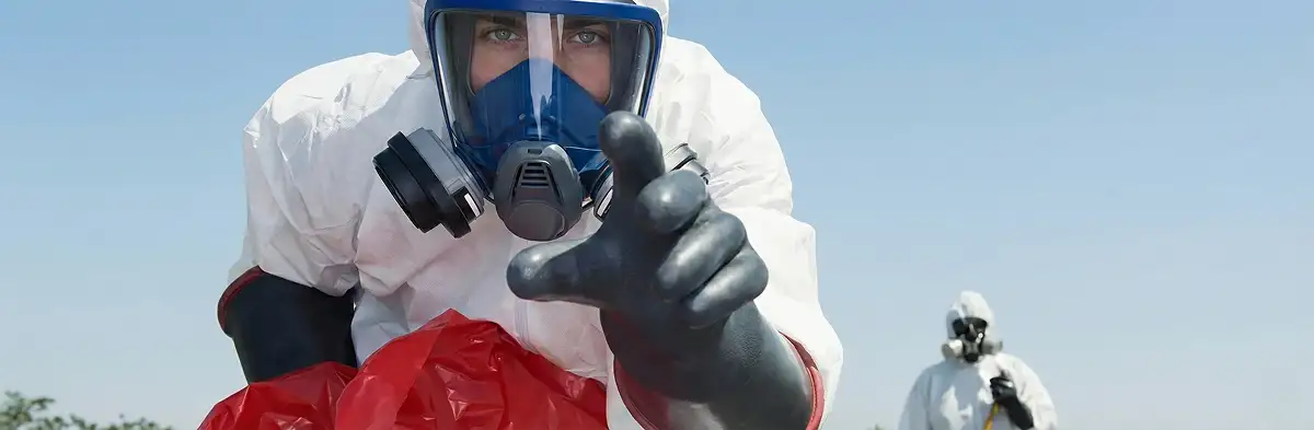 sewage clean up technician wearing protective gear handling biohazard materials in Bloomington, IN