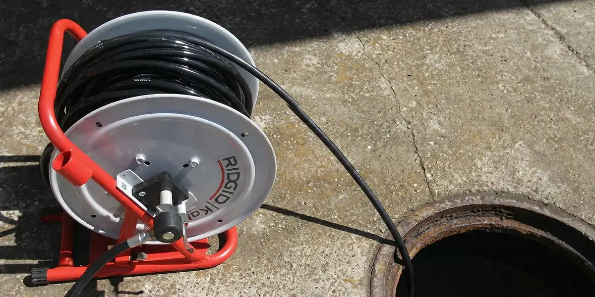 sewer rodding equipment prepared to clear clogged sewer lines in Bloomington, IN