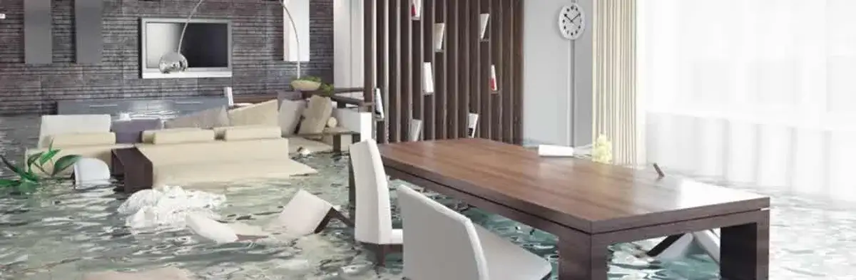 home interior affected by water damage with flooded floors and displaced furniture in Bloomington, IN